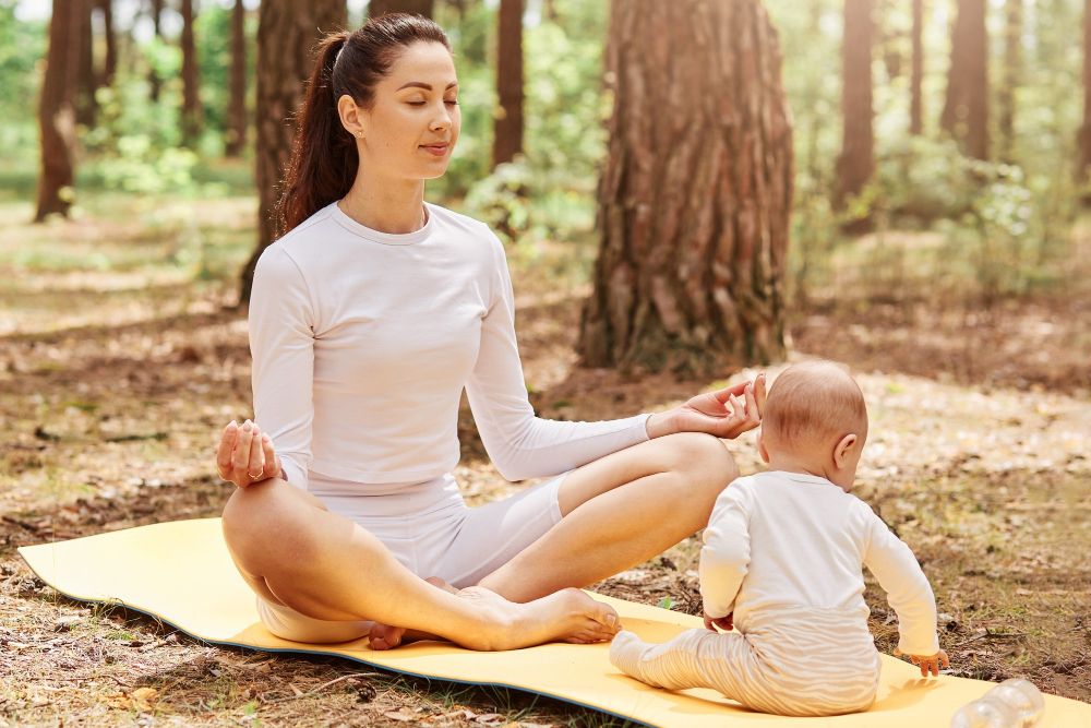 Portrait Attractive Woman Sitting Lotus Pose Meditating While Her Infant Daughter